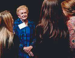 Julia Plotnick speak with several nursing students.